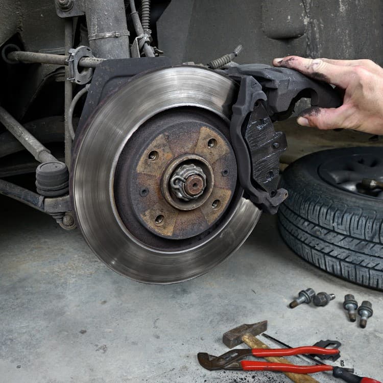 Brake rotor exposed with the caliper lifted off